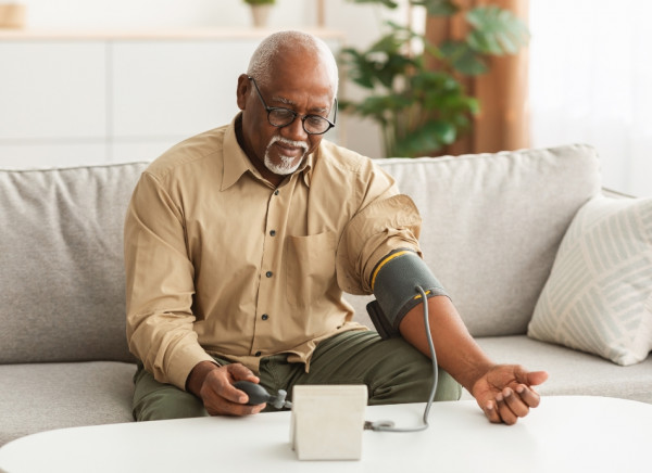 Man taking his blood pressure at home