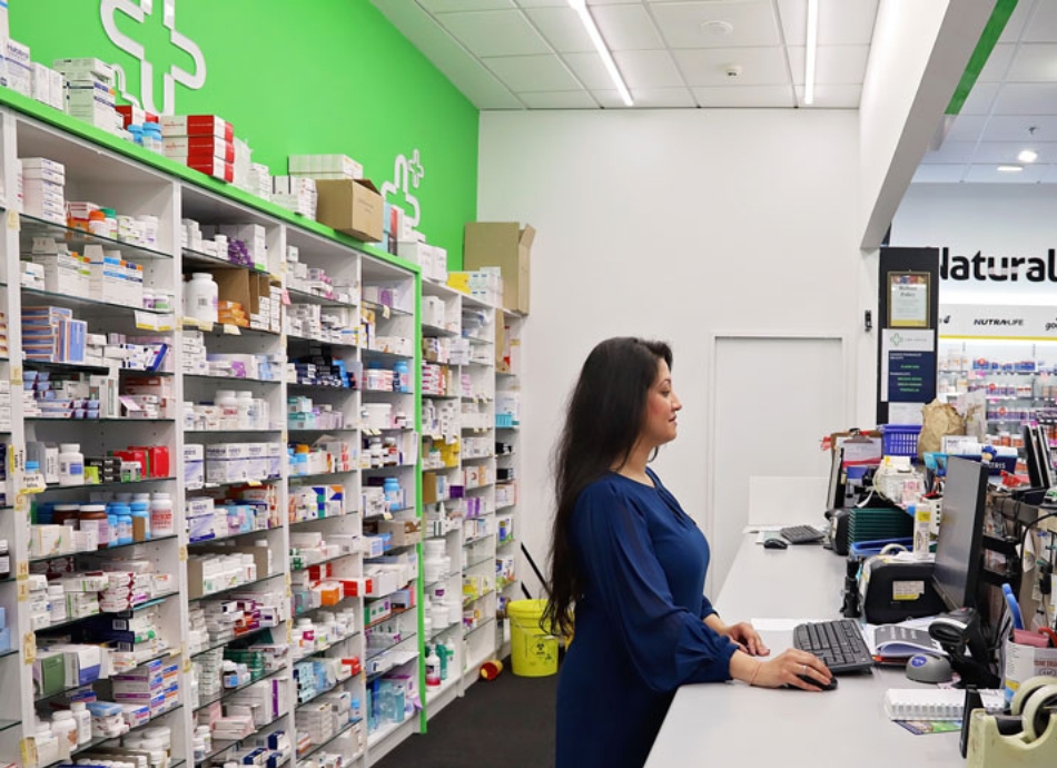 HN 0789 female pharmacist working in dispensary of community pharmacy 1