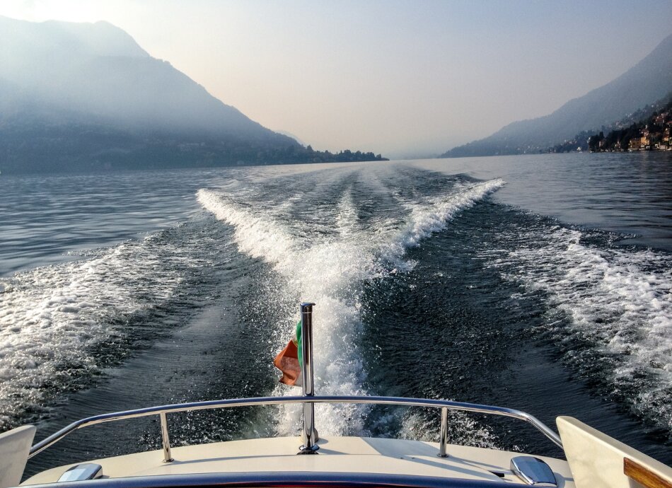 View of water and hills from the back of a boat 