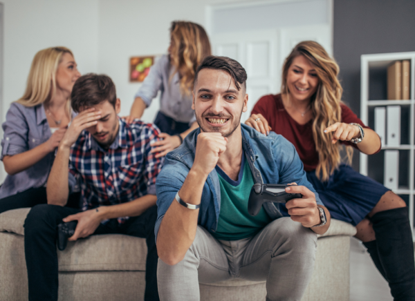 Friends playing video games on couch one feeling unwell